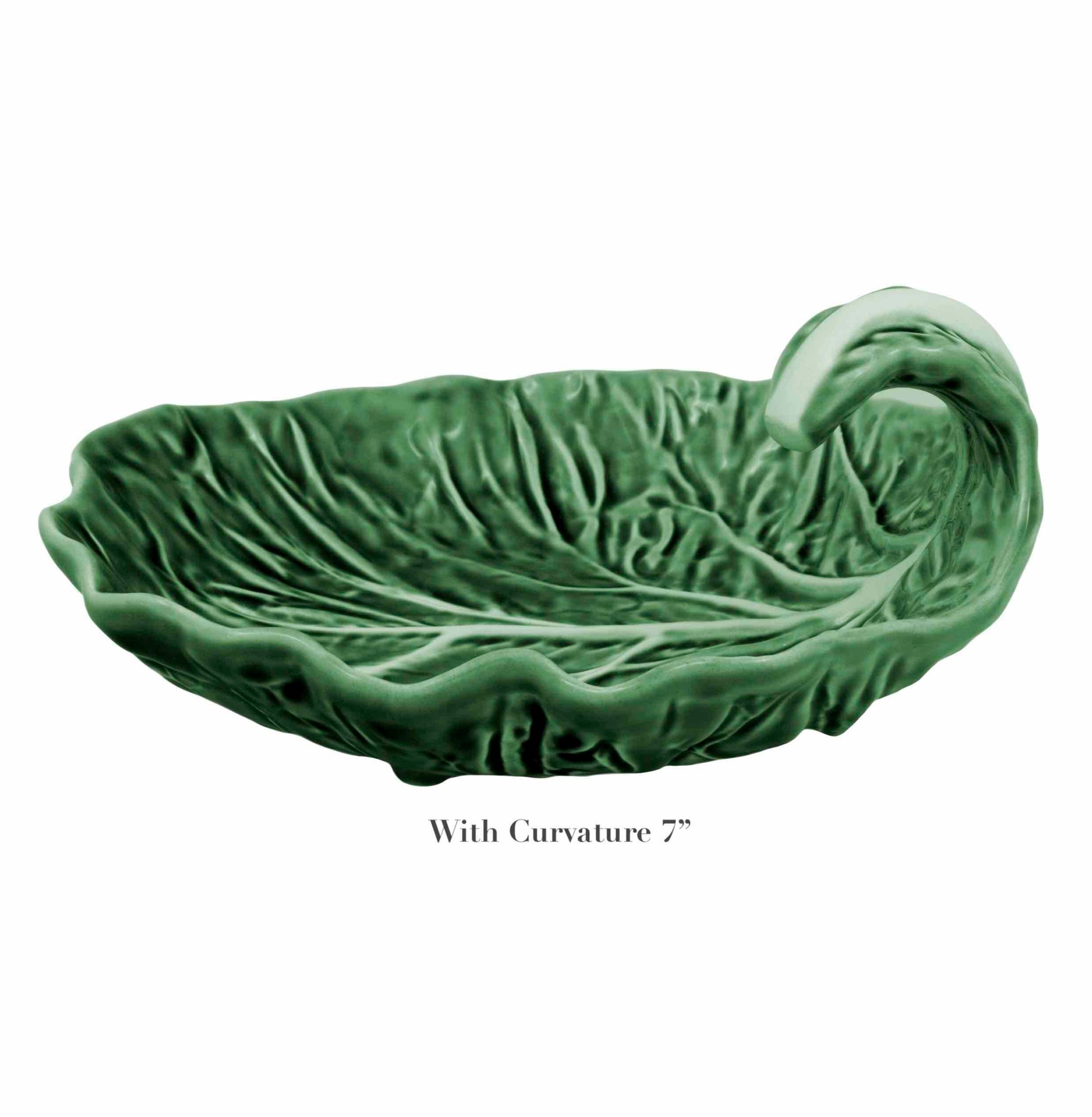 The Bordallo Pinheiro Cabbage Leaf Green Collection features a green ceramic dish resembling a curled leaf with a wavy edge. Handmade with care, it includes the text: "With Curvature 7".