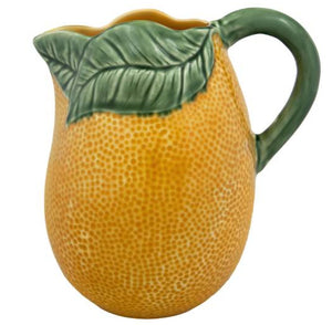 The Hive Orange Pitcher is a ceramic piece with a textured orange body and a green leaf-shaped handle—an ideal way to add zest and charm to your table.