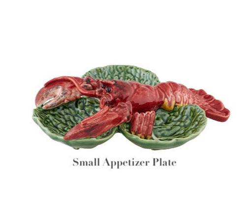 This Bordallo Pinheiro ceramic appetizer plate showcases a red lobster on a vivid green leaf backdrop, embodying the spirit of the Cabbage with Lobsters Serveware Collection.