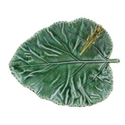 Part of the Bordallo Pinheiro Countryside Leaves Dish Collection, this whimsical earthenware catchall is shaped and painted like a green leaf, featuring a small ceramic insect on the upper right side.