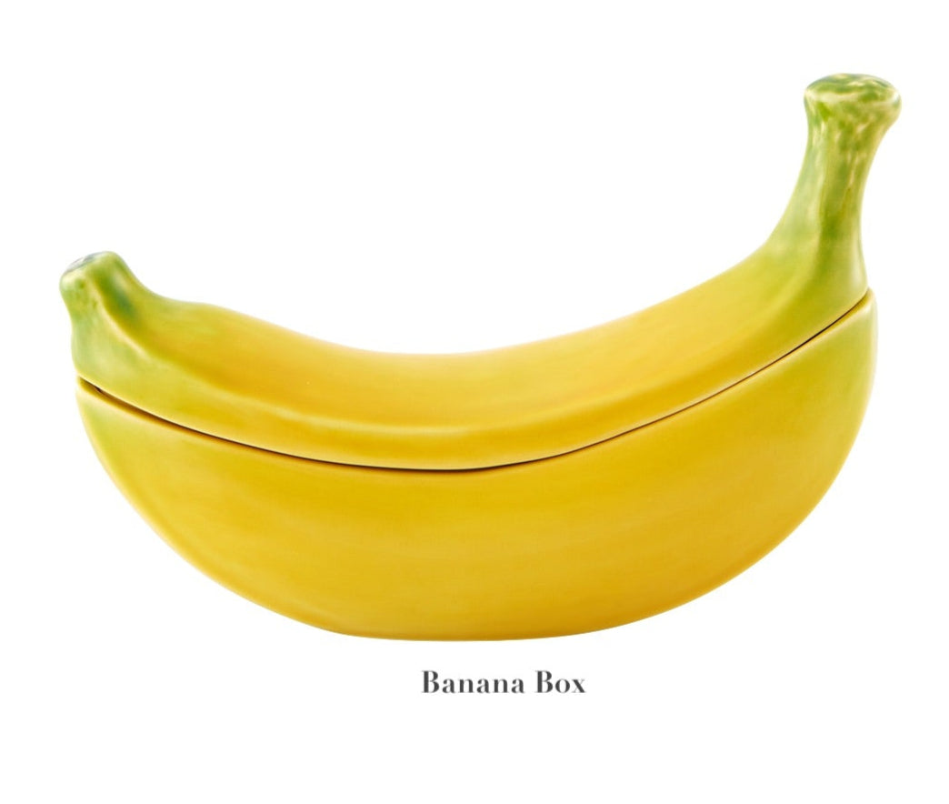 The Bananas From Madeira Serveware Collection by Bordallo Pinheiro features a ceramic banana-shaped container with lid—a fun, playful addition to your serveware.