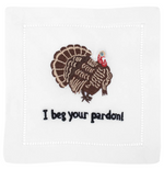 The August Morgan "I Beg your Pardon! Cocktail Napkins" are white cotton napkins with classic hemstitching, embroidered with a turkey above the phrase "I beg your pardon!" in black.