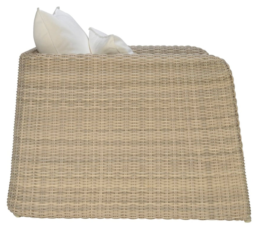 Side view of the Zeya Outdoor Lounge Chair by Janus et Cie, a tan wicker armchair with two white cushions, designed for weather-resistant outdoor use. Pictured against a white background.