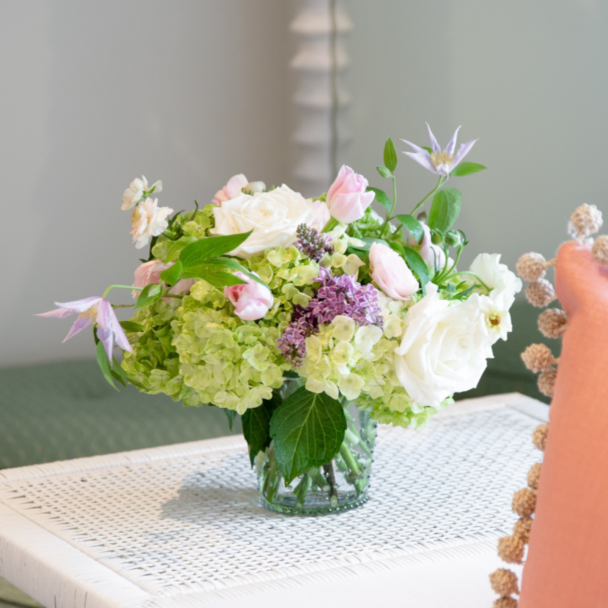 A Hive Floral Studio Live Designer's Choice floral arrangement on a white table.