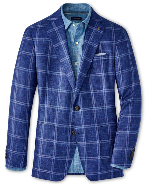 A Peter Millar Sola Windowpane Soft Jacket layered over a light blue button-up shirt.
