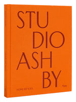 An orange book cover with the title "Studio Ashby: Home Art Soul" in large red letters, published by Rizzoli. The subtitle "HOME ART SOUL" is at the bottom, capturing the essence of vibrant interiors designed by renowned interior designer Ashley Hicks.
