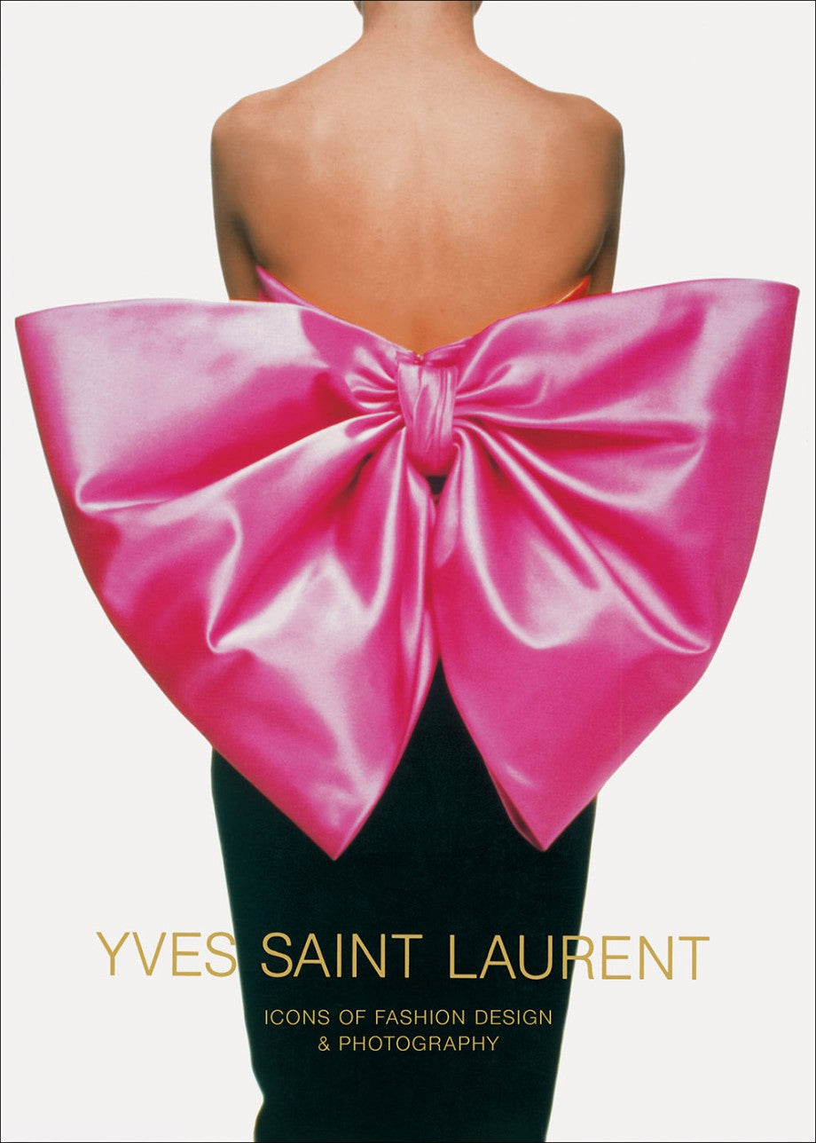 A person wears a strapless dress with a large, shiny pink bow. Below, text reads "Yves Saint Laurent" by Abrams—a book celebrating haute couture through stunning fashion photography.