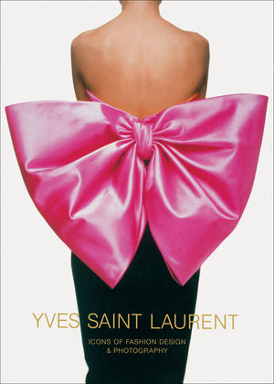 A person wears a strapless dress with a large, shiny pink bow. Below, text reads "Yves Saint Laurent" by Abrams—a book celebrating haute couture through stunning fashion photography.