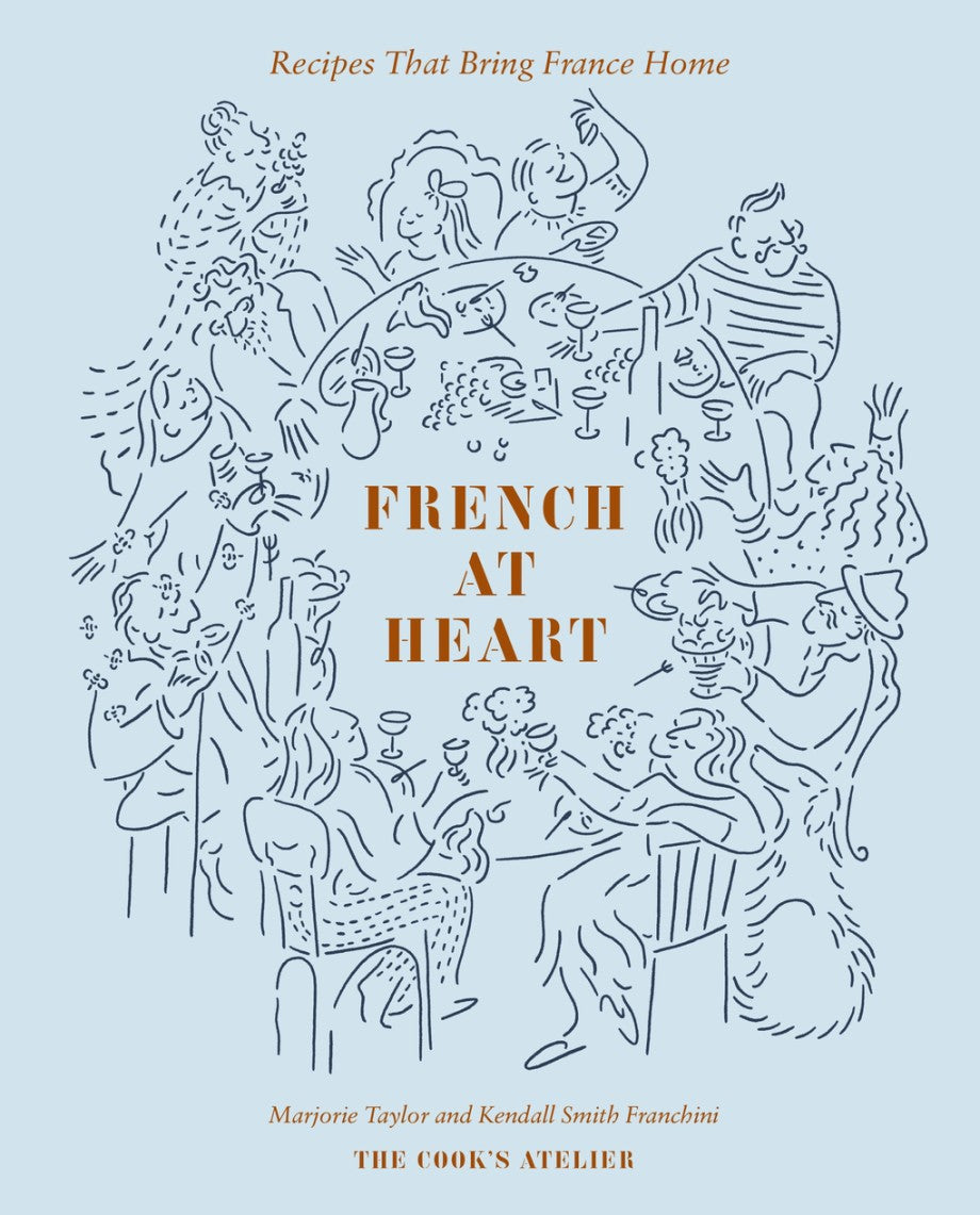 Cover of "French at Heart: Recipes That Bring France Home" by Abrams, featuring illustrated diners sharing wine—a French cookbook inspired by classic recipes.