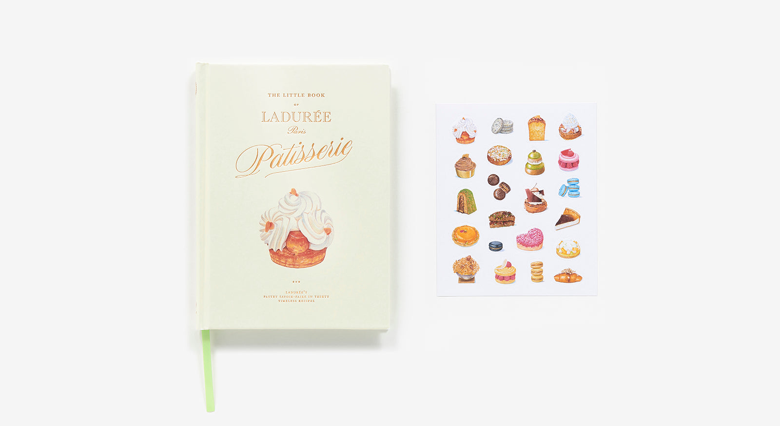 A pale green book, "The Little Book of Ladurée: Patisserie" by Abrams, rests beside a sheet of illustrated Parisian dessert stickers on a white background.