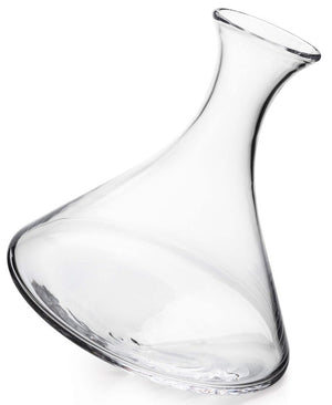 The Simon Pearce Walden Rolling Wine Decanter is a handmade clear glass decanter with a wide, flat base and flared neck, ideal for aerating wine. Shown on its side against a white background.