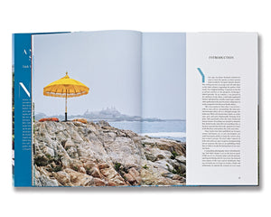 In "A Newport Summer" by Vendome, an open book features a left page with a photo of a yellow umbrella on Newport's rocky coast, and a right page with text under the "Introduction," echoing the Gilded Age houses scattered across Rhode Island's scenic landscape.