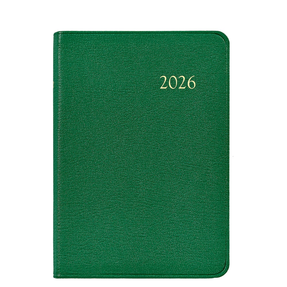 Photographed against a white background, the Graphic Image 2026 Daily Journal Planner Collection features a green hardcover with "2026" embossed in gold on the front.