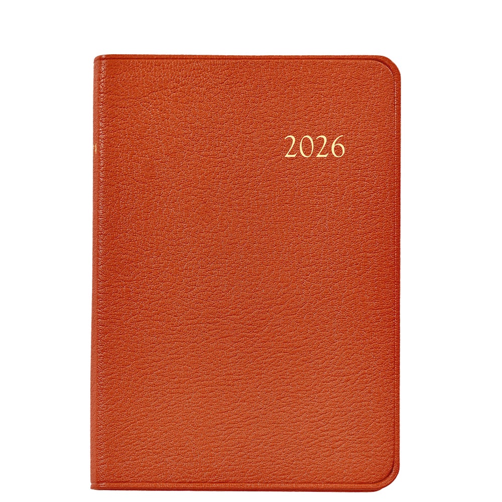 A closed Graphic Image 2026 Daily Journal Planner Collection, brown leather-bound with "2026" embossed in gold on the cover, photographed against a white background.