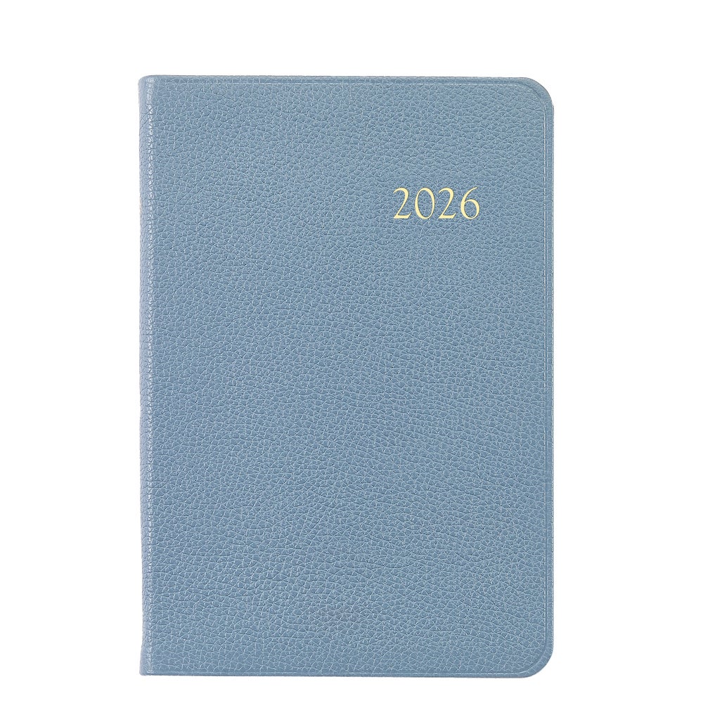 The Graphic Image 2026 Daily Journal Planner Collection features a blue textured diary with "2026" in gold on the cover, shown against a white background.