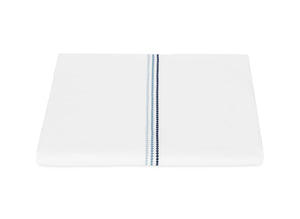Folded white Amara Triple Pearl Bedding Collection sheet by Matouk in Sailor Blue, featuring a blue dotted vertical stripe, displayed on a plain white background.