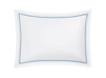The Amara Triple Pearl Bedding Collection pillow by Matouk features a blue and black dotted embroidery on luxurious white Amara Sateen. Sailor Blue colorway.
