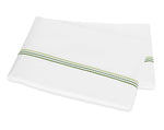 A folded white bedsheet from the Matouk Amara Triple Pearl Bedding Collection in Palm Green, featuring a double-row decorative green stitch near the edge.