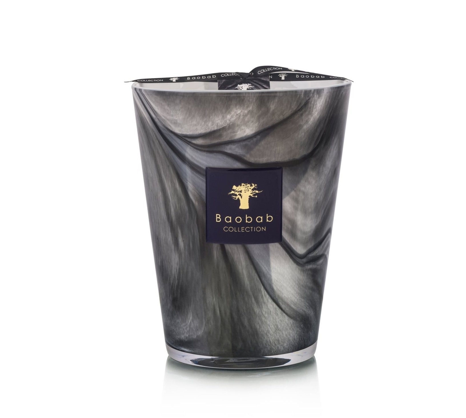 A tall candle from Baobab, labeled as the Atlas Toubkal Candle, features a marble-patterned design and is infused with hints of Atlas cedar and rose.
