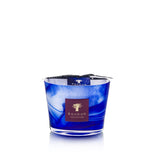 Baobab's Atlas Majorelle Candle is a blue glass candle holder with a marbled pattern, adorned with a purple Baobab Collection label on the front. Its design evokes the harmonious blend of aromatic patchouli and orange blossom.