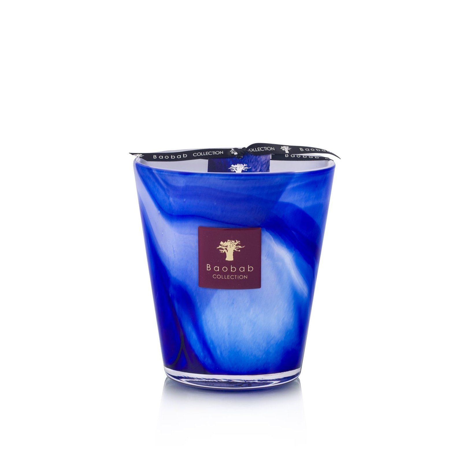 The Baobab Collection Atlas Majorelle Candle features a blue glass container adorned with a patterned blue and white design and is infused with the rich scent of patchouli.
