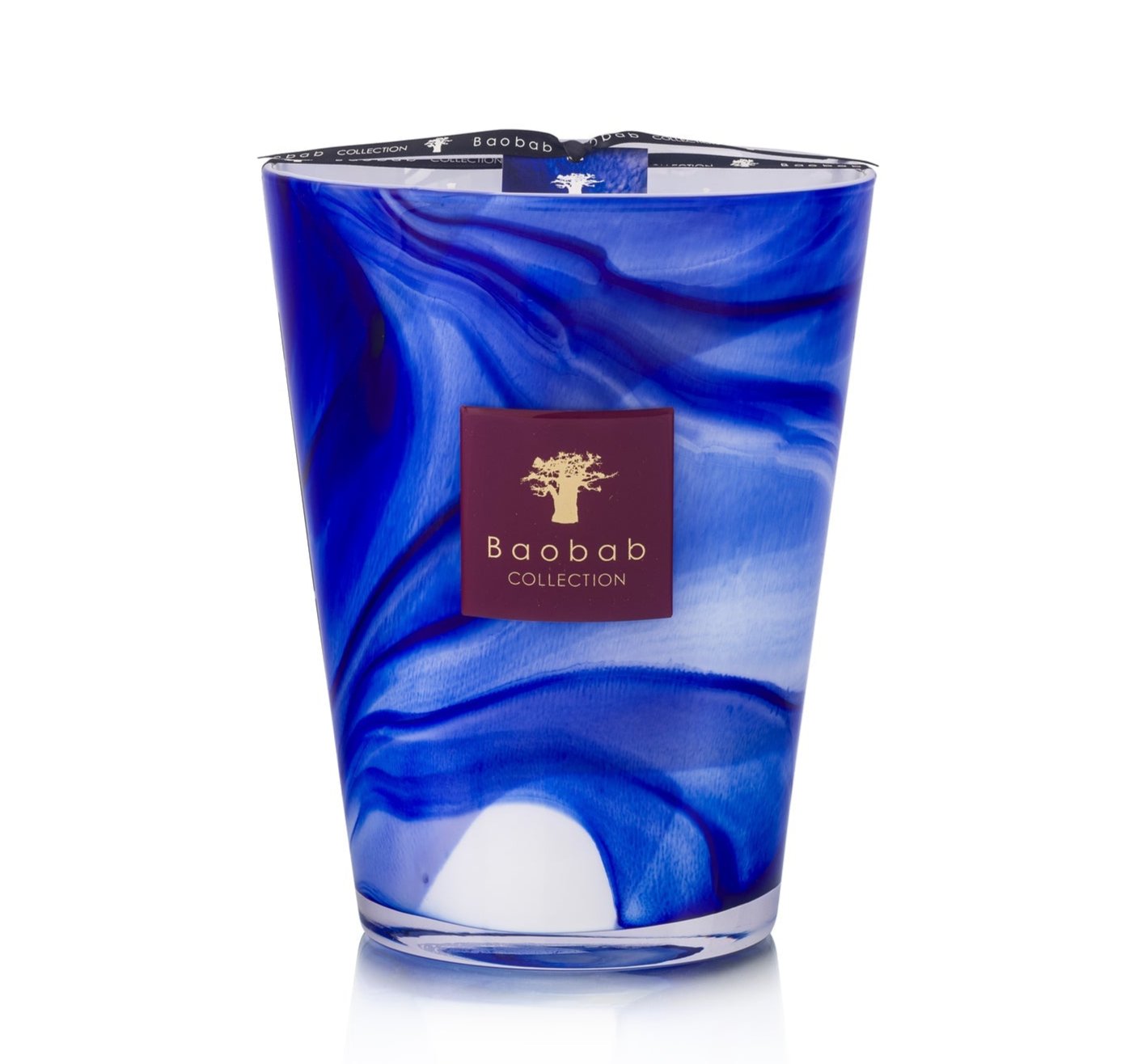 Blue and white marbled glass candle with a brown label featuring "Baobab," offering the subtle elegance of orange blossom, named the Atlas Majorelle Candle from Baobab Collection.