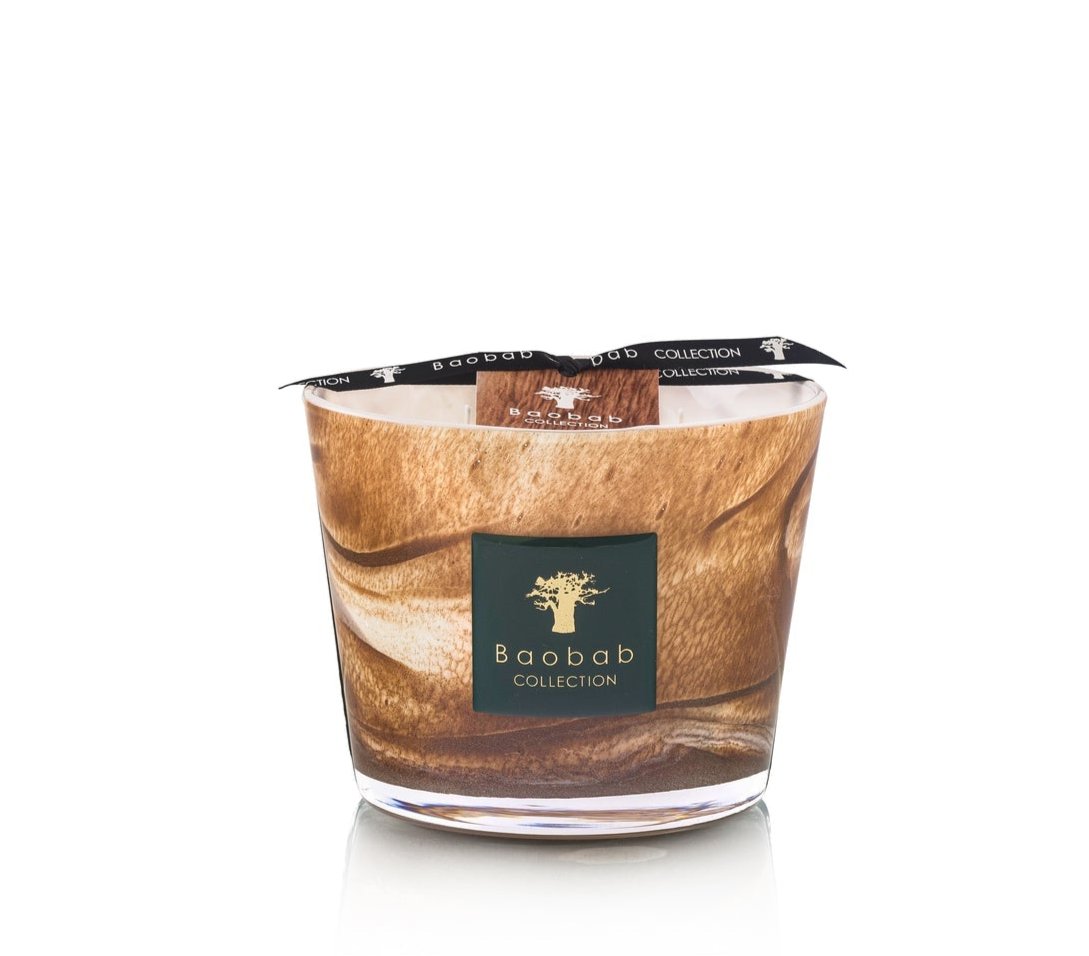 The Baobab Collection Atlas Tichka Candle in a glass holder with a marbled brown design and black ribbon exudes an earthy, rich patchouli aroma.