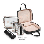 Introducing the Belize Raven Travel Collection by Stephanie Johnson: a stylish black and clear set with a large zippered briefcase, removable compartments, two clear cylindrical containers, a clear zip pouch, and a quilted black cylindrical pouch.