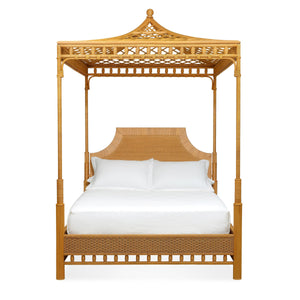 The Bunny Williams Rattan Trellis Canopy Bed features a striking lattice design, decorative headboard, white pillows, and a white mattress, shown against a plain background.