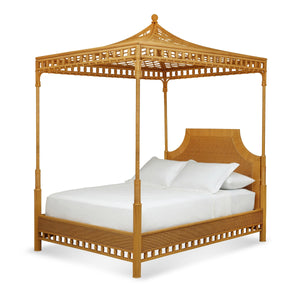 The Bunny Williams Rattan Trellis Canopy Bed features a trellis design, rattan frame, white bedding, and three pillows.