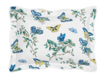 The Baudin Butterfly Blue Bedding Collection by Matouk features a white pillowcase with blue and yellow butterflies and green foliage, crafted from luxurious Egyptian cotton percale.