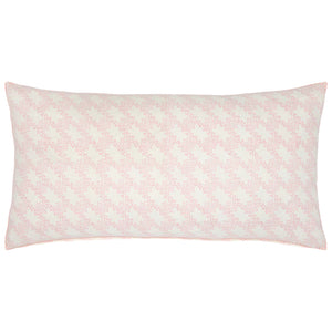 The Vikas Lotus Bolster by John Robshaw features a light pink geometric pattern on white, inspired by vintage tilework.