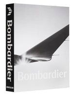 A hardcover book titled "The Impossible Collection of Bombardier" by Assouline showcases a black spine and a grayscale image of an aircraft wing on the cover, embodying the elegance of private jets and breakthroughs in business aviation.