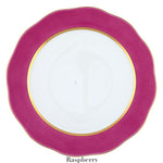 The Herend Silk Ribbons Charger is a handmade porcelain plate featuring a wavy, raspberry-colored rim and gold inner border—perfect for elevating any tabletop. "Raspberry" is written below.