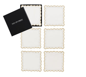 The Kim Seybert Arches Cocktail Napkin Set features six square white napkins with gold embroidered geometric edges, presented in a black branded box—an elegant addition to your holiday entertaining.