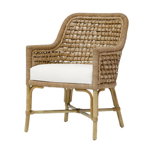 The Capitola Outdoor Arm Chair in Nit Witty Sea Salt by PALECEK features a woven back and sides in natural seagrass, wooden legs, and a white cushioned seat.