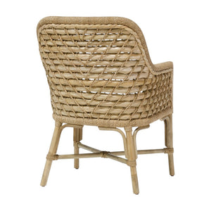 The PALECEK Capitola Outdoor Arm Chair in Nit Witty Sea Salt features a woven crisscross back and seat with natural wood legs, shown from the back.