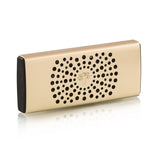 The Baobab Collection Car Diffuser by Baobab is a rectangular, gold-colored accessory with black ends, a central tree logo, and a circular hole pattern, designed for use with fragrance polymer beads in your car's air vent system.