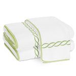 Two folded Matouk Classic Chain Bath Collection cotton terry towels with light green trim and a signature chain embroidered border, displayed side by side on a plain background.