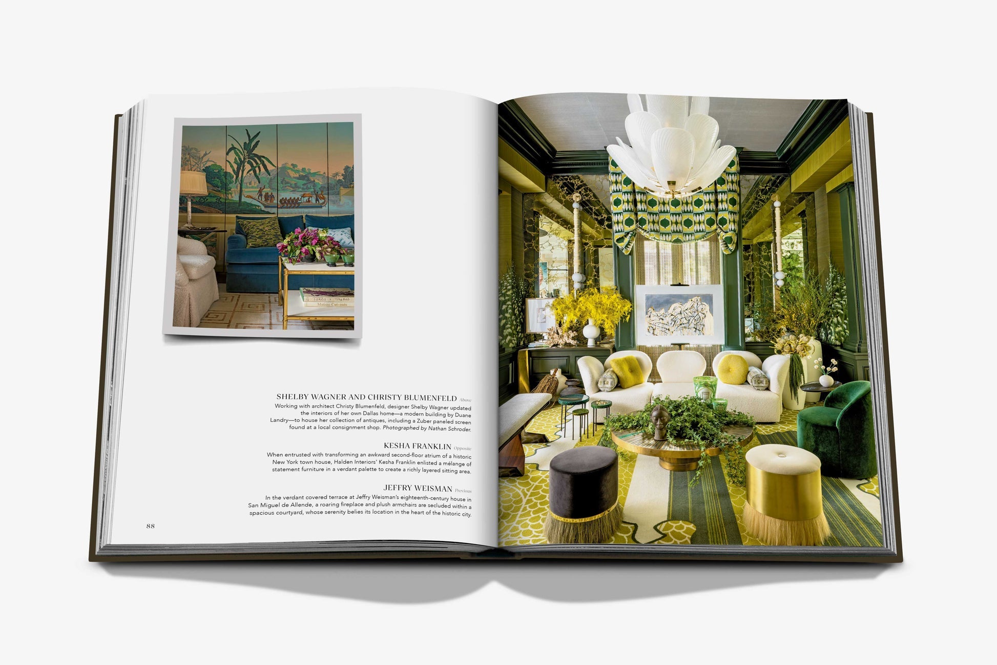 An open book, "The Living Room" by Assouline, features a photo of a colorful living room with green and yellow accents on the right and interior photography with text on the left, highlighting modern minimalism.