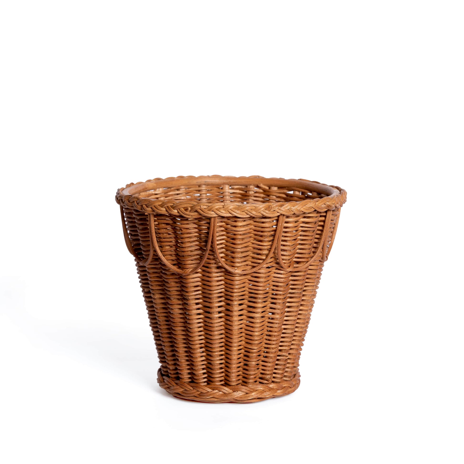 The Pinet Plant Pot Collection by Sharland England features a brown woven wicker basket with a flared top and looped rim pattern, ideal as a natural rattan houseplant holder, shown against a white background.