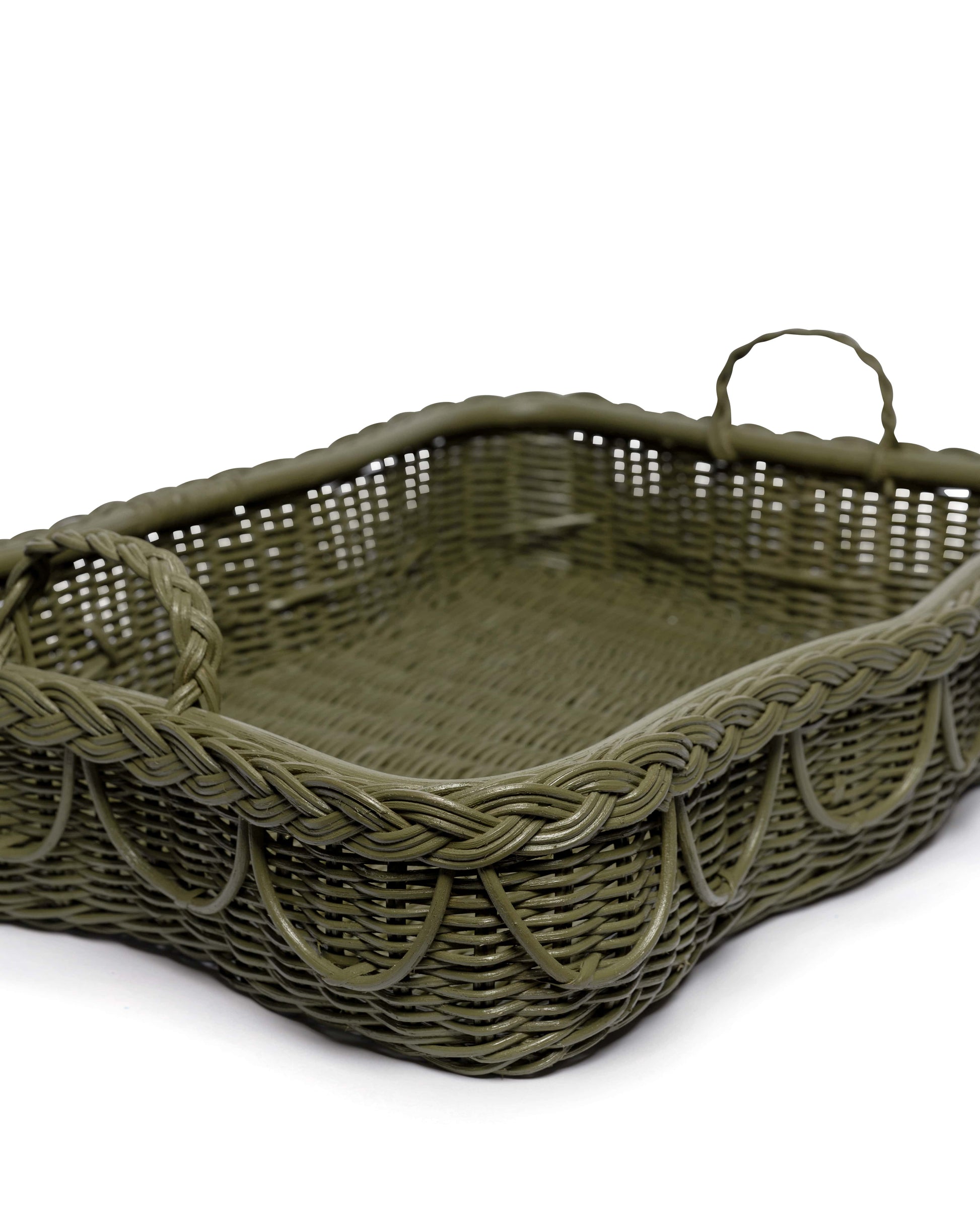 The Hadley Tray Collection by Sharland England features a rectangular green wicker basket with dual handles and hand-crafted braided scalloped edges, displayed against a white background.