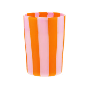 The Murano Dolcevita Stripe Tumbler Collection by Aquazzura Casa features handblown tumblers with vertical orange and pink stripes set against a white background.