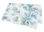 The Matouk Del Tesoro Bedding Collection, Sea, features folded fabric with a white background and a blue-green seaweed and seashell pattern, evoking an oceanic fantasy.