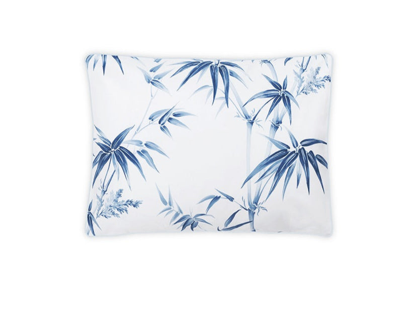 The Dominique Bedding Collection, Azure by Matouk features a rectangular white pillow made from OEKO-TEX® certified Egyptian cotton with a bold blue bamboo leaf pattern on a plain white background.