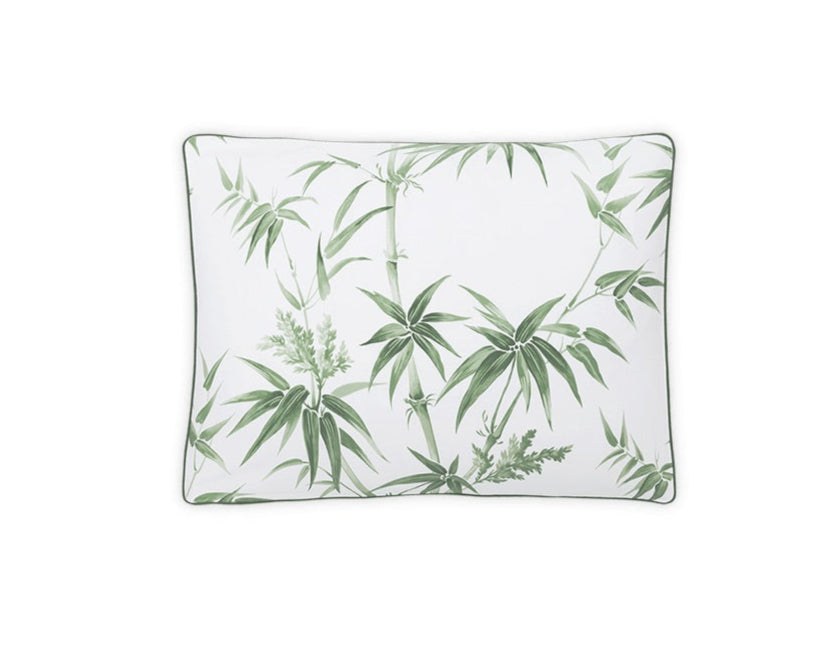 The Dominique Bedding Collection, Palm by Matouk features a rectangular pillow with a white background and green palm pattern, crafted from luxurious Egyptian cotton and OEKO-TEX Standard 100 certified for eco-friendly comfort.