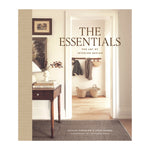 Abrams’ "The Essentials: The Art of Interior Design" features a stylish hallway scene with baskets, coats, and a side table—an inspiring book perfect for home decor enthusiasts.