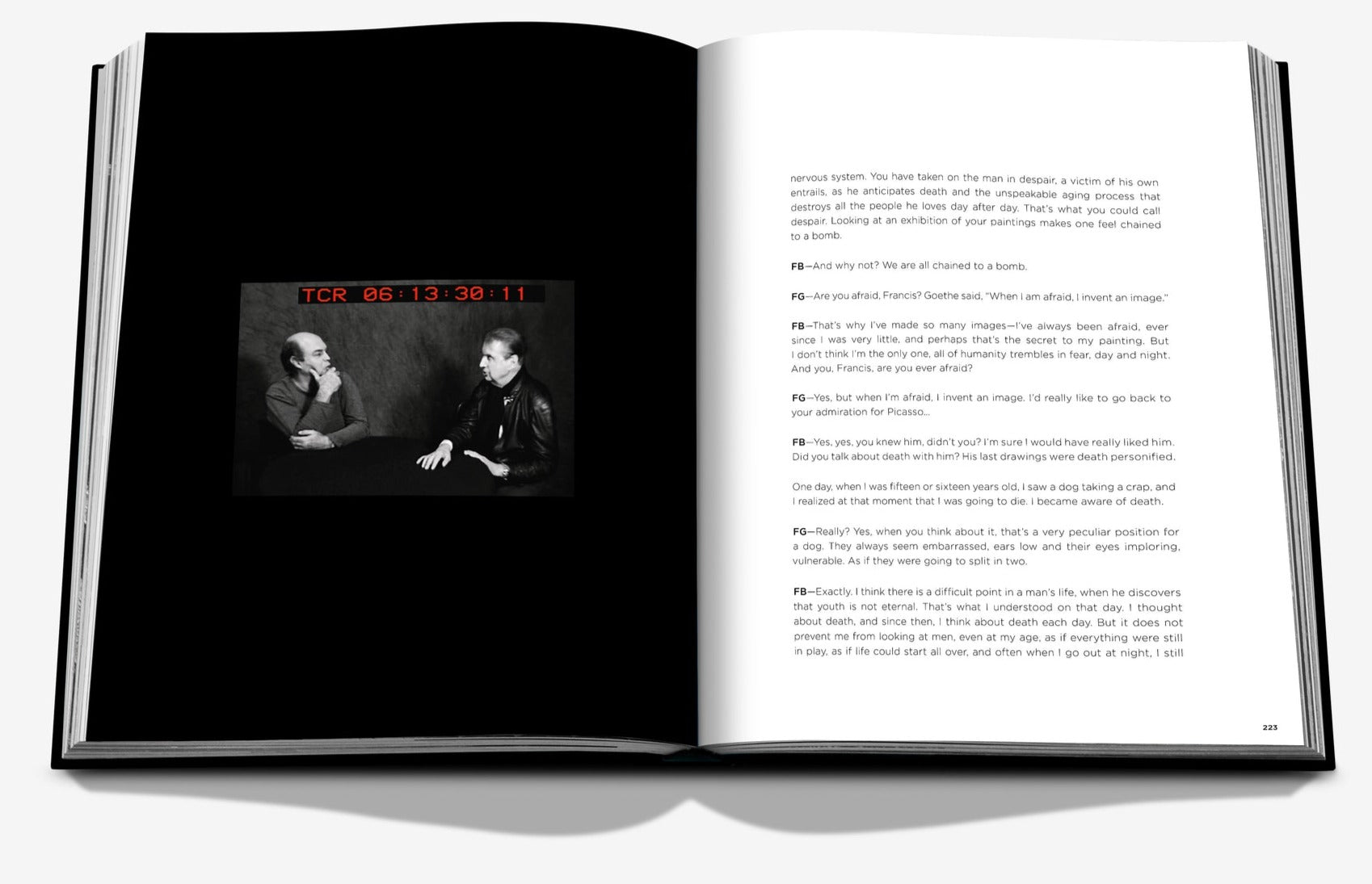 An open book with a black-and-white photo of two people talking on the left page and text on the right page, reminiscent of Francis Bacon's striking photography featured in Assouline.