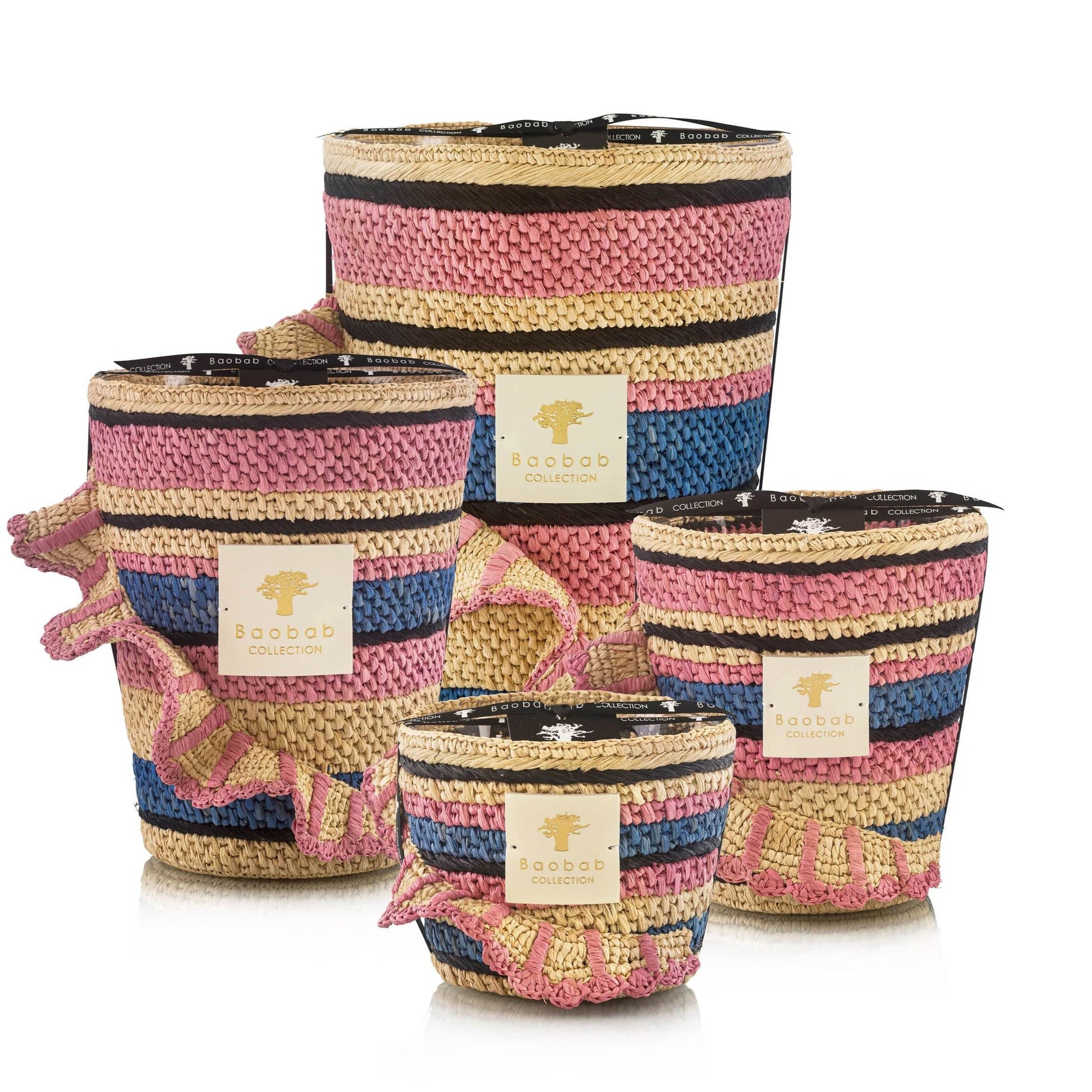 Four multi-colored woven baskets of varying sizes, each labeled "Baobab Collection," feature pink, blue, and beige stripes with intricate details. They're perfect for pairing with a Baobab Fety Mandihy Candle.
