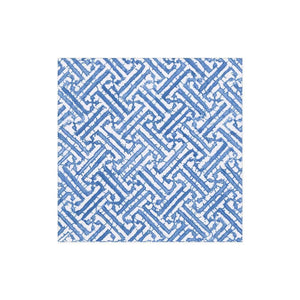 The Fretwork Collection by Caspari features a square tile with blue and white interlocking zigzag patterns, textured edges, and a durable design inspired by eco-friendly napkins.